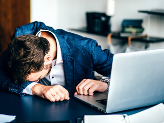 Sad businessman sitting at his desk.