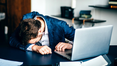 Sad businessman sitting at his desk.
