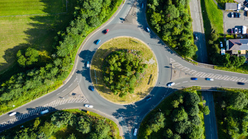 Aerial long exposure of traffic on a roundabout in a small town