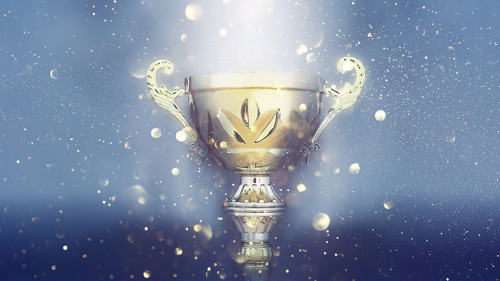 sports concept low key image of gold trophy over dark smoky background and glitter lights