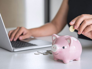Woman putting golden coin in pink piggy bank for step up growing
