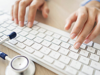Female doctor typing on computer