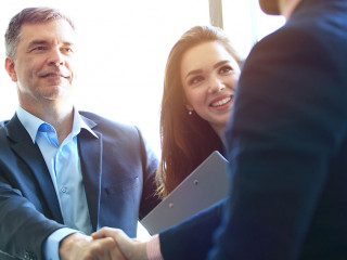 Business people shaking hands, finishing up a meeting.