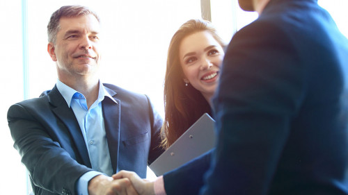 Business people shaking hands, finishing up a meeting.