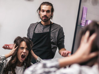 Young woman getting new hairstyle at professional hair styling s