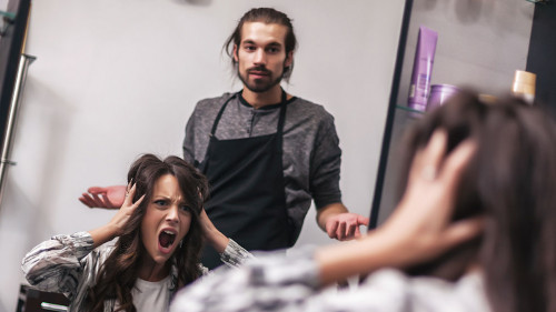 Young woman getting new hairstyle at professional hair styling s