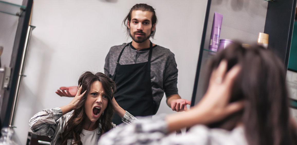 Young woman getting new hairstyle at professional hair styling s