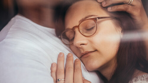 Couple in love embracing behind window