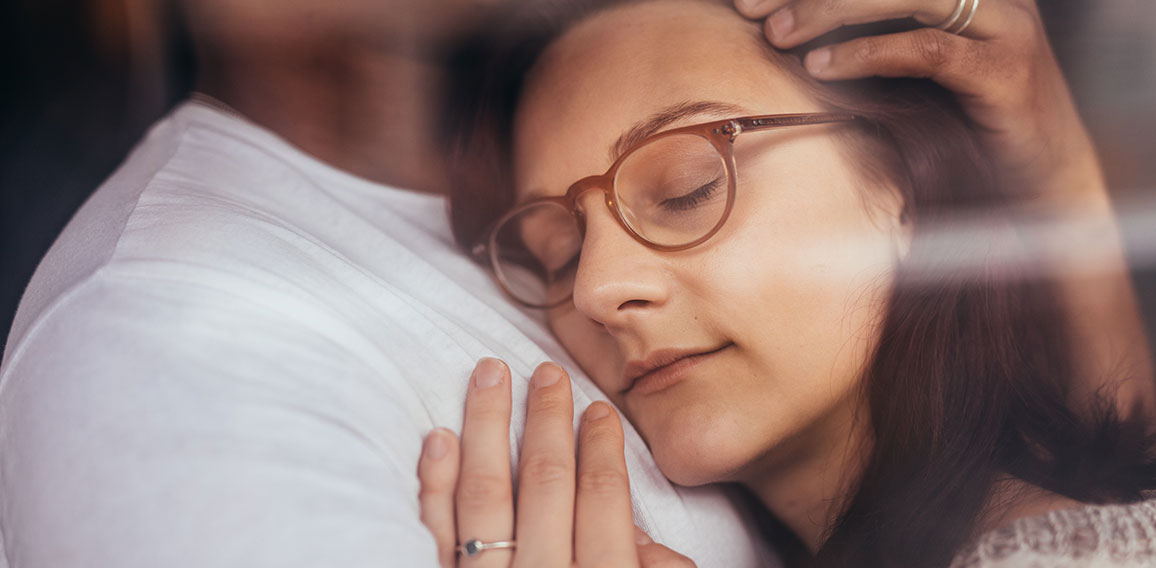 Couple in love embracing behind window