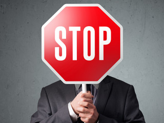 Businessman holding a stop sign
