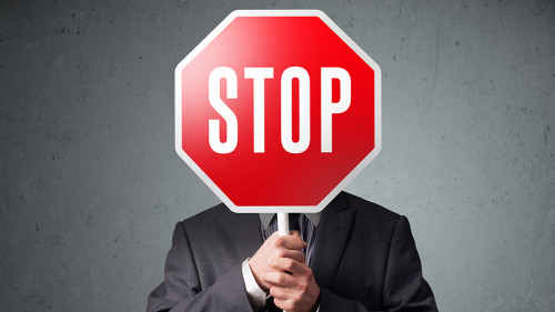 Businessman holding a stop sign