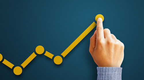 Businessman is touching arrows pointing up with graph as a symbo