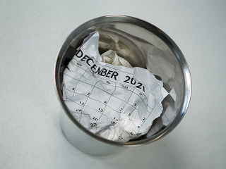 Crumpled calendar in dustbin