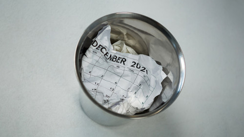 Crumpled calendar in dustbin