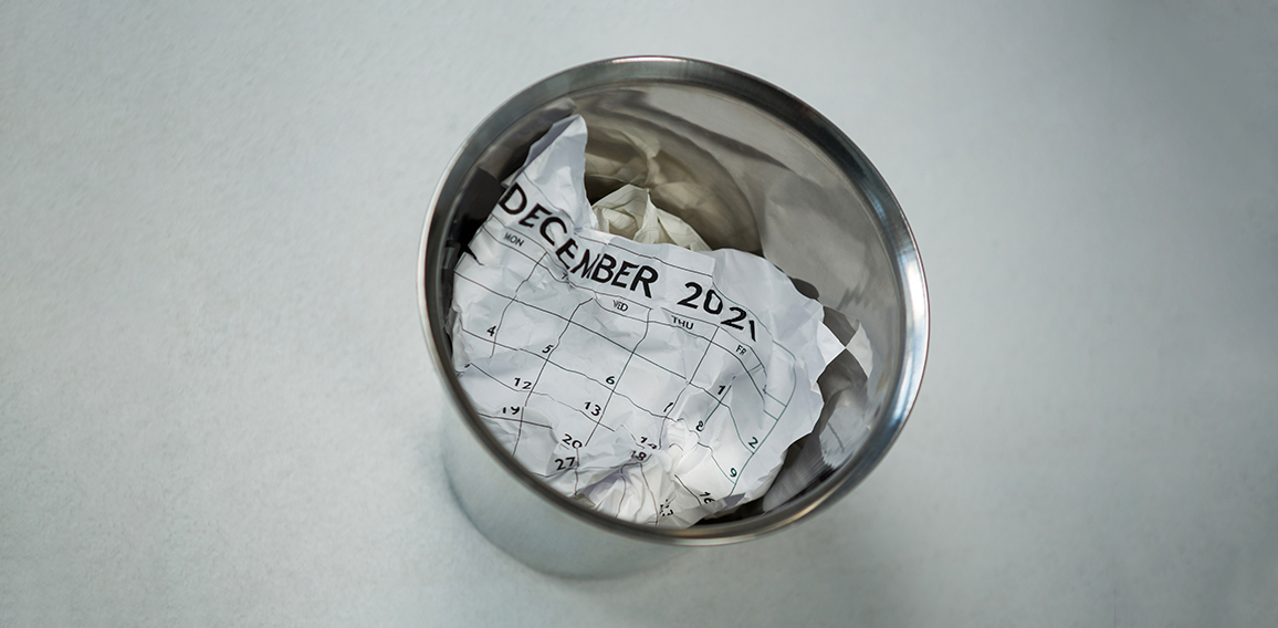 Crumpled calendar in dustbin