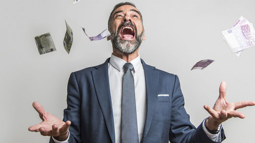 Excited senior business man throwing money, euro bills, in the a