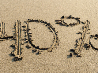 inscription on the sand minus forty percent, 40 %, sea wave on t