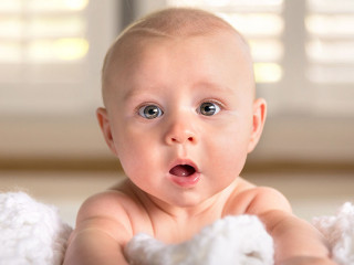 Surprised funny expression cute puffy chubby cheeks big blue eye