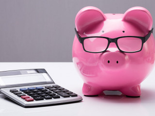 Piggybank With Eyeglasses And Calculator