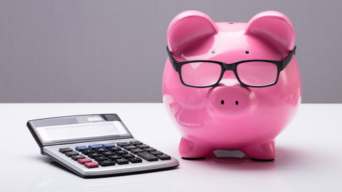Piggybank With Eyeglasses And Calculator