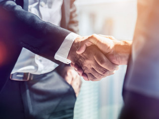 Businessman handshake for teamwork of business merger and acquis