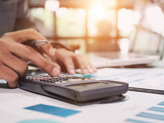 Insurance agent using calculator for medical insurance, the poli