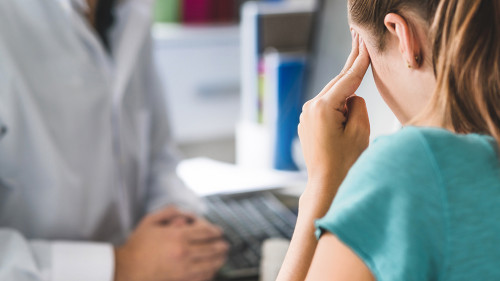 Woman suffering from bad headache or migraine. Appointment with