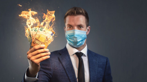 Businessman with a protective face mask is loosing money