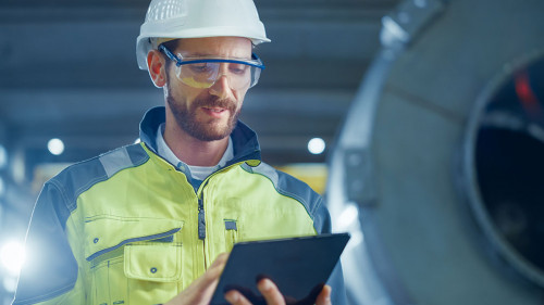 Portrait of Professional Heavy Industry Engineer / Worker Wearin