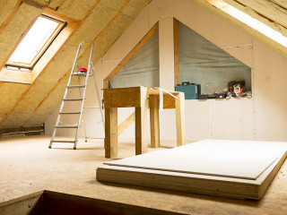 house attic under construction mansard wall insulation with rock