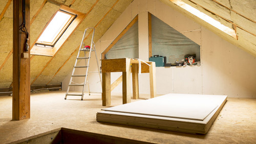 house attic under construction mansard wall insulation with rock