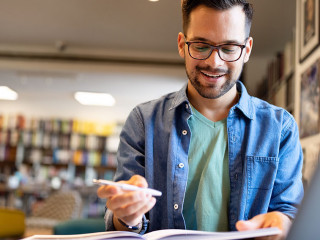 Student preparing exam and learning lessons in school library