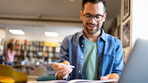 Student preparing exam and learning lessons in school library