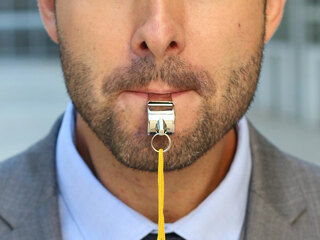 Businessman blowing a white isolated