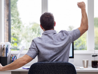 Rear View Of Man Working From Home On Computer  In Home Office S