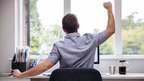 Rear View Of Man Working From Home On Computer In Home Office S