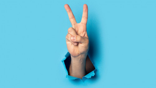 Male hand makes a two fingers up greeting gesture on a blue background. Banner