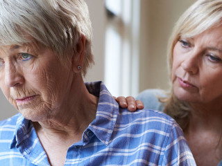Serious Senior Woman With Adult Daughter At Home