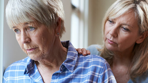 Serious Senior Woman With Adult Daughter At Home