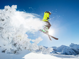 Skier at jump in Alpine mountains