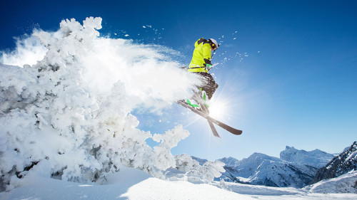 Skier at jump in Alpine mountains