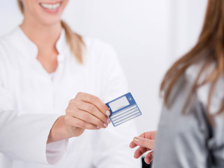 patientin und arzthelferin mit versicherungskarte