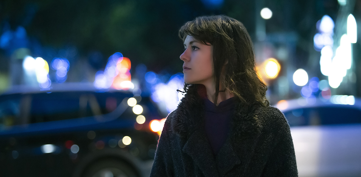 Woman Walking At Night in the City