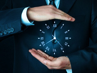 Businessman holding clock. Business time management .