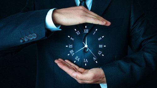 Businessman holding clock. Business time management .