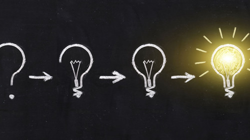 Black and white light bulb using doodle art on chalkboard backgr