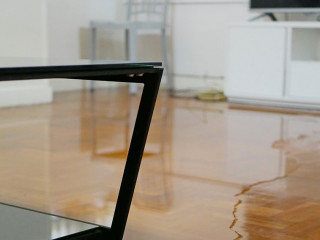 Close up of water flooding on living room parquet floor in a hou