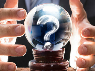 Businessman Covering Crystal Ball With Question Mark