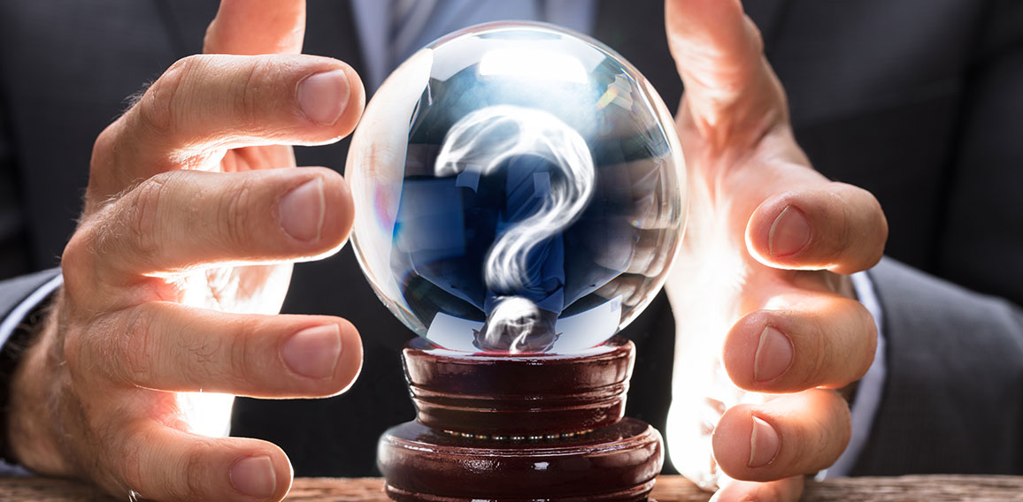 Businessman Covering Crystal Ball With Question Mark