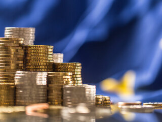 Towers with euro coins and flag of European Union in the background